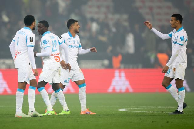 (From L to R) Marseille's English defender #04 Conrad Jaden Egan-Riley, Marseille's US forward #22 Timothy Weah, Marseille's Italian defender #33 Emerson Palmieri and Marseille's English forward #10 Mason Greenwood celebrate their victory at the end of the French L1 football match between OGC Nice and Olympique de Marseille (OM) at the Allianz Riviera stadium in Nice, south-eastern France, on November 21, 2025. (Photo by Valery HACHE / AFP)