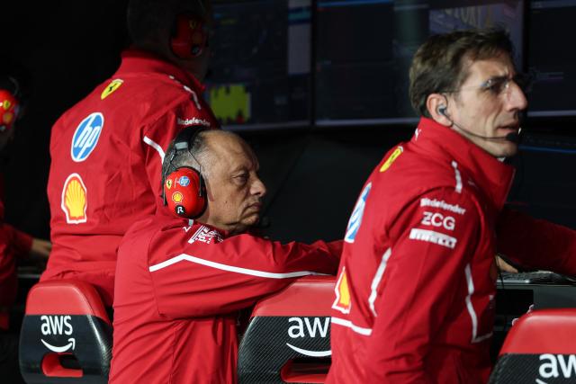 Ferrari's French team principal Frederic Vasseur (L) sits along the pit wall before the start of the third practice session for the Las Vegas Formula One Grand Prix at the Las Vegas Strip Circuit in Las Vegas, Nevada, on November 21, 2025. (Photo by Patrick T. Fallon / AFP)