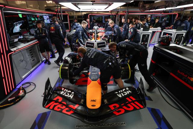Technicians work on the car of Red Bull Racing's Japanese driver Yuki Tsunoda in the garage during the third practice session for the Las Vegas Formula One Grand Prix at the Las Vegas Strip Circuit in Las Vegas, Nevada, on November 21, 2025. (Photo by Patrick T. Fallon / AFP)