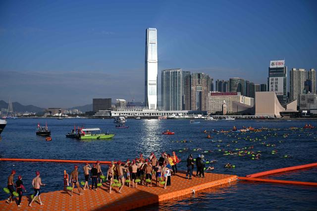Participants take part in the Harbour Race, where swimmers cross Hong Kong's Victoria Harbour, in the city on November 22, 2025. (Photo by Peter PARKS / AFP)