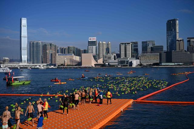 Participants take part in the Harbour Race, where swimmers cross Hong Kong's Victoria Harbour, in the city on November 22, 2025. (Photo by Peter PARKS / AFP)