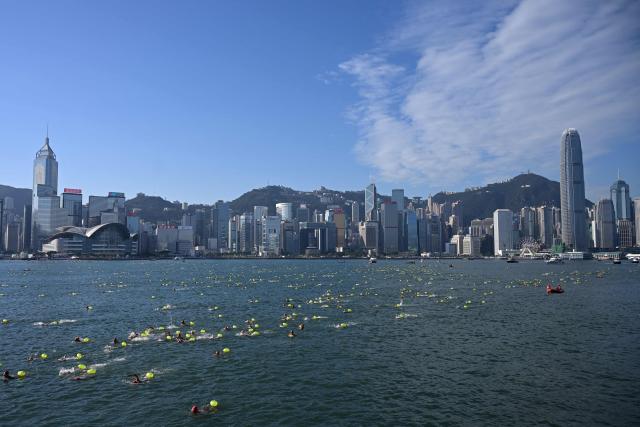 Participants take part in the Harbour Race, where swimmers cross Hong Kong's Victoria Harbour, in the city on November 22, 2025. (Photo by Peter PARKS / AFP)