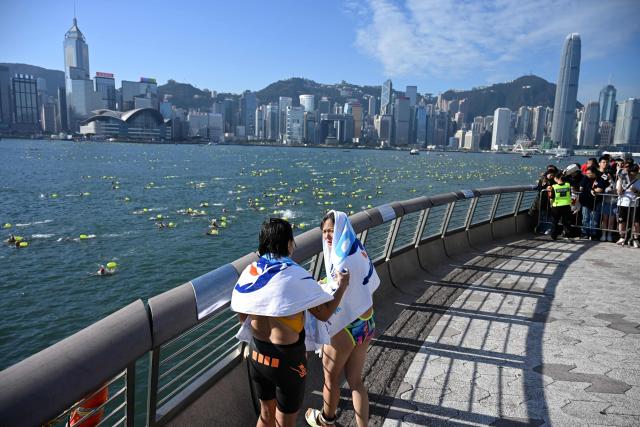 Participants take part in the Harbour Race, where swimmers cross Hong Kong's Victoria Harbour, in the city on November 22, 2025. (Photo by Peter PARKS / AFP)