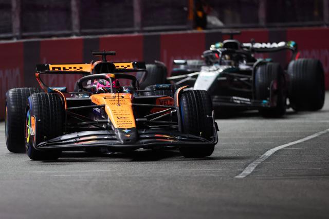 McLaren's Australian driver Oscar Piastri (L) and Mercedes' British driver George Russell (R) race during the qualifying session for the Las Vegas Formula One Grand Prix at the Las Vegas Strip Circuit in Las Vegas, Nevada, on November 21, 2025. (Photo by Patrick T. Fallon / AFP)