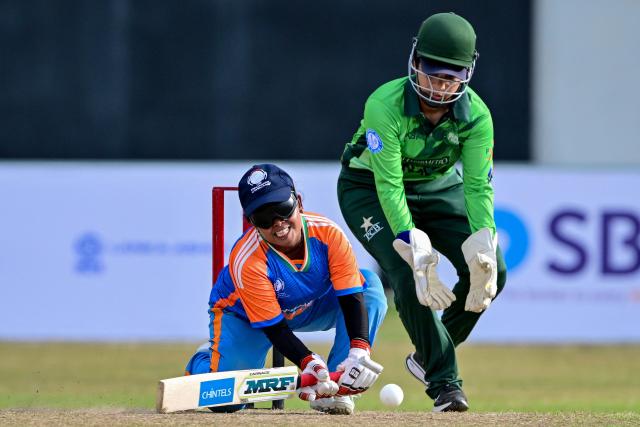 (FILES) India's Simu Das (L) plays a shot during the Women’s Blind Twenty20 World Cup 2025 match between India and Pakistan at the BOI Cricket Stadium in Katunayake on November 16, 2025. On a lush cricket ground outside Colombo the sharp jingling of a ball cuts through the afternoon air. Every rattle is a pushback against the stigma of disability. Sri Lanka and India are co-hosting the first T20 World Cup for visually impaired women. (Photo by Ishara S. KODIKARA / AFP)