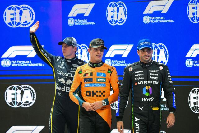 (L/R) Red Bull Racing's Dutch driver Max Verstappen (2nd position), pole position winner McLaren's British driver Lando Norris, and Williams' Spanish driver Carlos Sainz (3rd position) gather on stage after the qualifying session for the Las Vegas Formula One Grand Prix at the Las Vegas Strip Circuit in Las Vegas, Nevada, on November 21, 2025. (Photo by Frederic J. Brown / AFP)