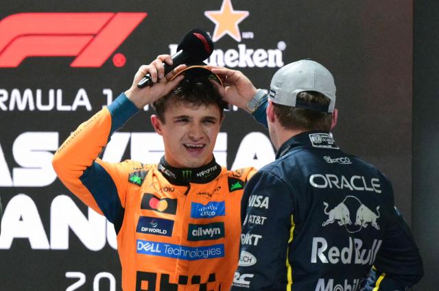 (L/R) Pole position winner McLaren's British driver Lando Norris speaks to 2nd place finisher Red Bull Racing's Dutch driver Max Verstappen after the qualifying session for the Las Vegas Formula One Grand Prix at the Las Vegas Strip Circuit in Las Vegas, Nevada, on November 21, 2 025. (Photo by Frederic J. Brown / AFP)