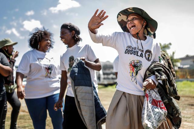 A member of the vigilante group known as Operation Dudula, which means "push back" in Zulu, gestures during a protest near the Nasrec Expo Centre in Johannesburg on November 22, 2025, ahead of the opening of the G20 Leaders’ Summit. Operation Dudula is protesting against the South African government turning a blind eye to corruption, joblessness, rising crime, illegal immigration and failing public services. (Photo by Marco Longari / AFP)