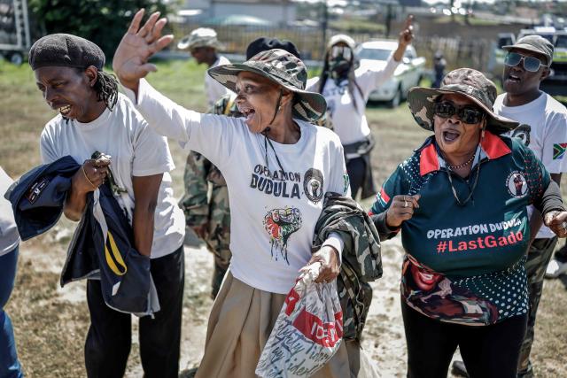 A member of the vigilante group known as Operation Dudula, which means "push back" in Zulu, gestures during a protest near the Nasrec Expo Centre in Johannesburg on November 22, 2025, ahead of the opening of the G20 Leaders’ Summit. Operation Dudula is protesting against the South African government turning a blind eye to corruption, joblessness, rising crime, illegal immigration and failing public services. (Photo by Marco Longari / AFP)