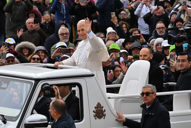 Pope Leo XIV (C) waves to the crowd from the papamobile as he arrives to the audience of Jubilee of Choirs and Choral Society in St. Peter's Square, in the Vatican on November 22, 2025. (Photo by Andreas SOLARO / AFP)
