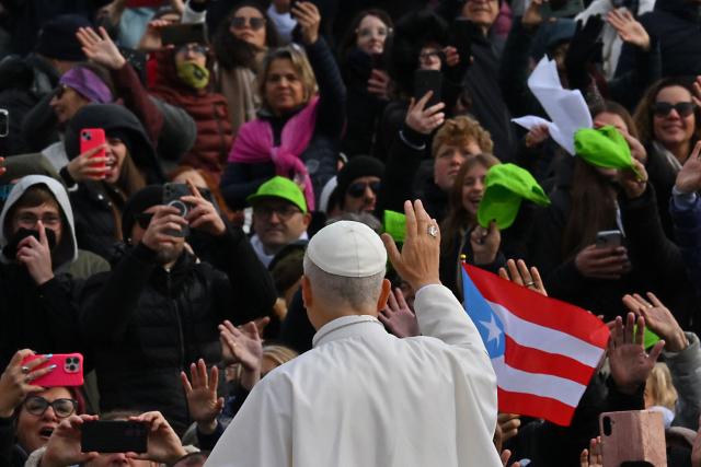Pope Leo XIV (C) waves to the crowd from the papamobile as he arrives to the audience of Jubilee of Choirs and Choral Society in St. Peter's Square, in the Vatican on November 22, 2025. (Photo by Andreas SOLARO / AFP)