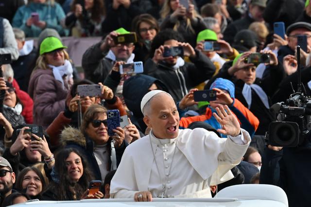 Pope Leo XIV (C) waves to the crowd from the papamobile as he arrives to the audience of Jubilee of Choirs and Choral Society in St. Peter's Square, in the Vatican on November 22, 2025. (Photo by Andreas SOLARO / AFP)