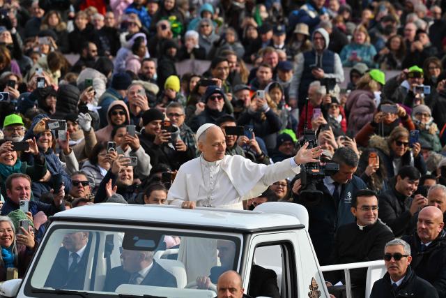 Pope Leo XIV (C) waves to the crowd from the papamobile as he arrives to the audience of Jubilee of Choirs and Choral Society in St. Peter's Square, in the Vatican on November 22, 2025. (Photo by Andreas SOLARO / AFP)