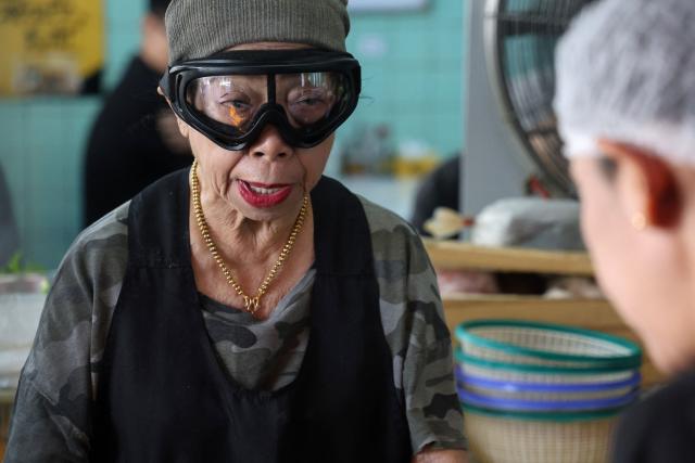 Michelin star chef Jay Fai, a longtime icon of Thai street food culture, looks on at her restaurant in Bangkok on November 22, 2025. (Photo by Sebastien BERGER / AFP)