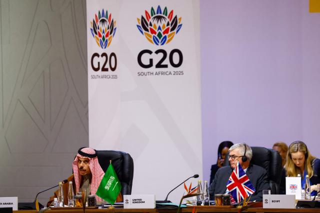 Saudi Arabia's Foreign Minister Faisal bin Farhan Al Saud (L) speaks during a G20 Leaders' Summit plenary session at the Nasrec Expo Centre in Johannesburg on November 22, 2025. (Photo by Thomas Mukoya / POOL / AFP)