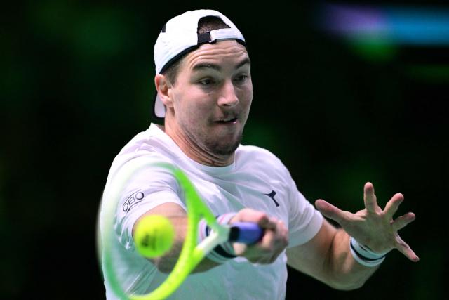 Germany's Jan-Lennard Struff plays a forehand return to Spain's Pablo Carreno Busta during their 2025 Davis Cup semi-final single tennis match at the Super Tennis Arena in Bologna, northen Italy, on November 22, 2025. (Photo by Tiziana FABI / AFP)