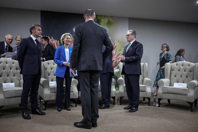 France’s President Emmanuel Macron (3rd L), European Commission President Ursula Von der Leyen (5th L), German Chancellor Friedrich Merz (C) and Britain's Prime Minister Keir Starmer (3rd R) arrive ahead of the G7++ meeting at the G20 Leaders' Summit at the Nasrec Expo Centre in Johannesburg on November 22, 2025. (Photo by HENRY NICHOLLS / POOL / AFP)
