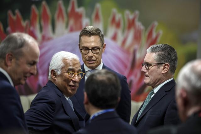 Britain's Prime Minister Keir Starmer (2nd R), German Chancellor Friedrich Merz (C) and European Council President Antonio Costa (2nd L) talk ahead of the G7++ meeting at the G20 Leaders' Summit at the Nasrec Expo Centre in Johannesburg on November 22, 2025. (Photo by HENRY NICHOLLS / POOL / AFP)