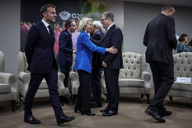 France’s President Emmanuel Macron (L), European Commission President Ursula Von der Leyen (3rd L), German Chancellor Friedrich Merz (C) and Britain's Prime Minister Keir Starmer (R) arrive ahead of the G7++ meeting at the G20 Leaders' Summit at the Nasrec Expo Centre in Johannesburg on November 22, 2025. (Photo by HENRY NICHOLLS / POOL / AFP)