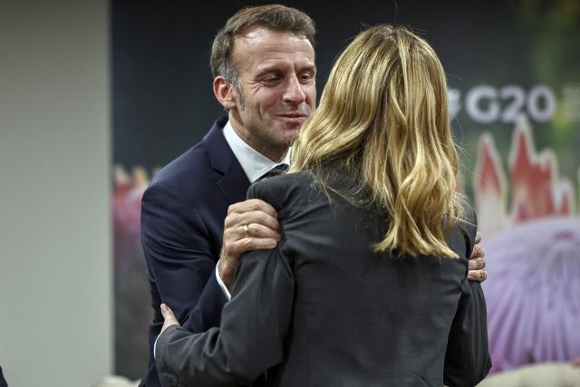 France’s President Emmanuel Macron (L) greets Italy’s Prime Minister Giorgia Meloni (R) ahead of the G7++ meeting at the G20 Leaders' Summit at the Nasrec Expo Centre in Johannesburg on November 22, 2025. (Photo by HENRY NICHOLLS / POOL / AFP)