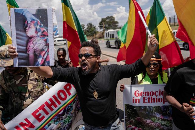 Members of the All United Amhara Association protest near the Nasrec Expo Centre in Johannesburg on November 22, 2025, calling for an end to the persecution of the Amhara people in Ethiopia and opposing Ethiopian Prime Minister Abiy Ahmed Ali's attendance at the G20 Leaders' Summit. (Photo by Ihsaan Haffejee / AFP)