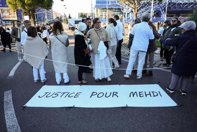 Protesters gather to take part in a march in tribute to Mehdi Kessaci, brother of ecologist and anti-drug activist Amine Kessaci, and to protest against drug trafficking, in Marseille, southern France on November 22, 2025. Mehdi Kessaci, the 22-year-old younger brother of Amine Kessaci, who wanted to become a police officer, was shot dead near a concert hall by two people on a motorbike, on November 13. More than a week after this tragedy, Mehdi Kessaci's family is calling for a gathering at the roundabout where he was murdered by two men on a motorbike under the slogan: "Justice for Mehdi, 20, who died for nothing". Other initiatives are planned in some 25 towns and cities. (Photo by CLEMENT MAHOUDEAU / AFP)