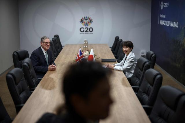 Britain's Prime Minister Keir Starmer (L) and Japan's Prime Minister Sanae Takaichi (R) attend a bilateral meeting at the G20 Leaders' Summit at the Nasrec Expo Centre in Johannesburg on November 22, 2025. (Photo by HENRY NICHOLLS / POOL / AFP)