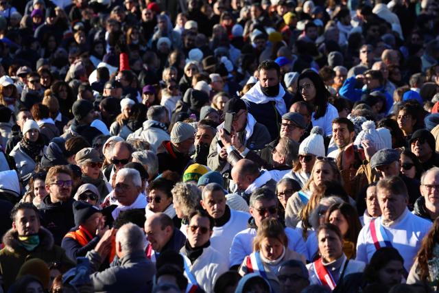People gather to take part in a march in tribute to Mehdi Kessaci, brother of ecologist and anti-drug activist Amine Kessaci, at the roundabout where he was murdered, and to protest against drug trafficking, in Marseille, southern France, on November 22, 2025. Mehdi Kessaci, the 22-year-old younger brother of Amine Kessaci, who wanted to become a police officer, was shot dead near a concert hall by two people on a motorbike, on November 13. More than a week after this tragedy, Mehdi Kessaci's family is calling for a gathering at the roundabout where he was murdered by two men on a motorbike under the slogan: "Justice for Mehdi, 20, who died for nothing". Other initiatives are planned in some 25 towns and cities. (Photo by CLEMENT MAHOUDEAU / AFP)