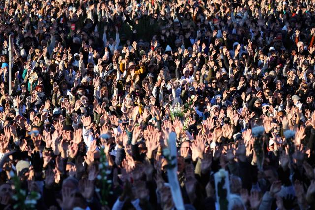 People gather to take part in a march in tribute to Mehdi Kessaci at the roundabout where he was murdered  and to protest against drug trafficking, in Marseille, southern France on November 22, 2025. Mehdi Kessaci, the 22-year-old younger brother of Amine Kessaci, who wanted to become a police officer, was shot dead near a concert hall by two people on a motorbike, on November 13. More than a week after this tragedy, Mehdi Kessaci's family is calling for a gathering at the roundabout where he was murdered by two men on a motorbike under the slogan: "Justice for Mehdi, 20, who died for nothing". Other initiatives are planned in some 25 towns and cities. (Photo by CLEMENT MAHOUDEAU / AFP)