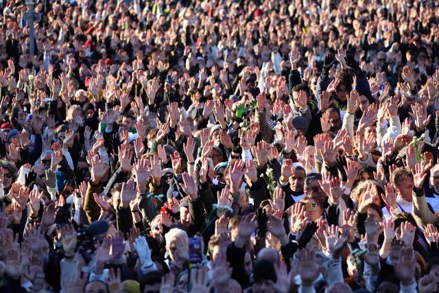 TOPSHOT - People gather to take part in a march in tribute to Mehdi Kessaci at the roundabout where he was murdered  and to protest against drug trafficking, in Marseille, southern France on November 22, 2025. Mehdi Kessaci, the 22-year-old younger brother of Amine Kessaci, who wanted to become a police officer, was shot dead near a concert hall by two people on a motorbike, on November 13. More than a week after this tragedy, Mehdi Kessaci's family is calling for a gathering at the roundabout where he was murdered by two men on a motorbike under the slogan: "Justice for Mehdi, 20, who died for nothing". Other initiatives are planned in some 25 towns and cities. (Photo by CLEMENT MAHOUDEAU / AFP)