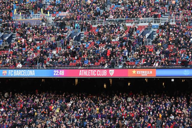 Fans take their seats ahead of the Spanish league football match between FC Barcelona and Athletic Club Bilbao at Camp Nou Stadium in Barcelona on November 22, 2025. (Photo by Josep LAGO / AFP)