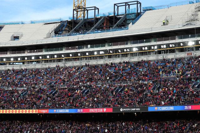 Fans take their seats ahead of the Spanish league football match between FC Barcelona and Athletic Club Bilbao at Camp Nou Stadium in Barcelona on November 22, 2025. (Photo by Josep LAGO / AFP)