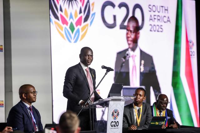 South Africa's Minister of International Relations and Cooperation, Ronald Lamola (C), speaks at a press conference during the G20 Leaders’ Summit at the Nasrec Expo Centre in Johannesburg on November 22, 2025. (Photo by Ludovic MARIN / AFP)