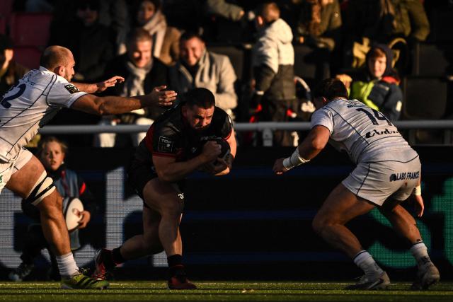Lyon's French hooker Guillaume Marchand challenges Clermont's French wing Lucas Tauzin (R) during the French Top14 rugby union match between Lyon Olympique Universitaire Rugby (LOU Rugby) and ASM Clermont Auvergne at the Matmut Stadium de Gerland, in Lyon, on November 22, 2025. (Photo by JEFF PACHOUD / AFP)