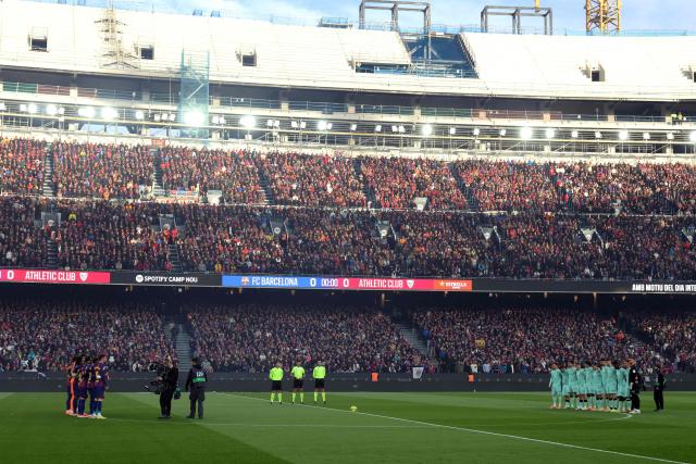 Both teams' players observe a minute of silence before the Spanish league football match between FC Barcelona and Athletic Club Bilbao at Camp Nou Stadium in Barcelona on November 22, 2025. (Photo by Lluis GENE / AFP)