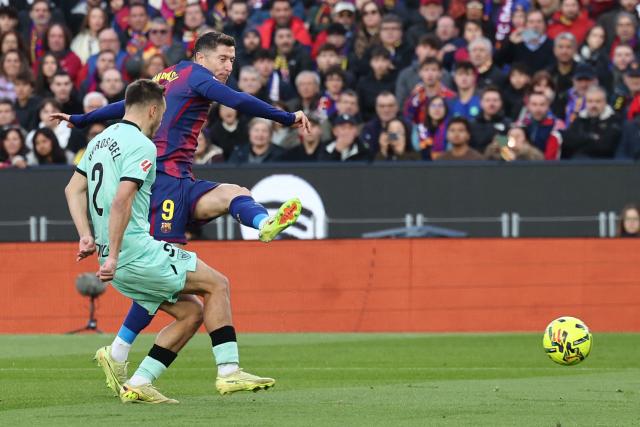 Barcelona's Polish forward #09 Robert Lewandowski scores the opening goal during the Spanish league football match between FC Barcelona and Athletic Club Bilbao at Camp Nou Stadium in Barcelona on November 22, 2025. (Photo by Josep LAGO / AFP)