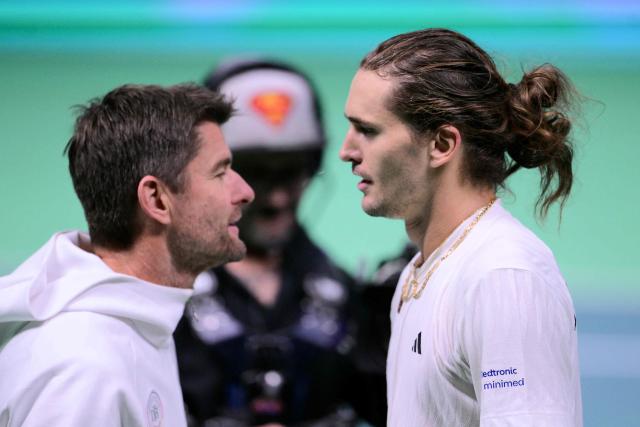 Germany's Alexander Zverev (R) is congratulated by Germany's captain Michael Kohlmann after winning over Spain's Jaume Munar at the end of their 2025 Davis Cup semi-final single tennis match at the Super Tennis Arena in Bologna, northen Italy, on November 22, 2025. (Photo by Tiziana FABI / AFP)