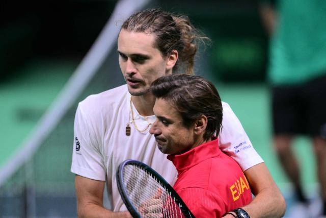 Germany's Alexander Zverev (L) celebrates his victory over Spain's Jaume Munar (R) at the end of their 2025 Davis Cup semi-final single tennis match at the Super Tennis Arena in Bologna, northen Italy, on November 22, 2025. (Photo by Tiziana FABI / AFP)