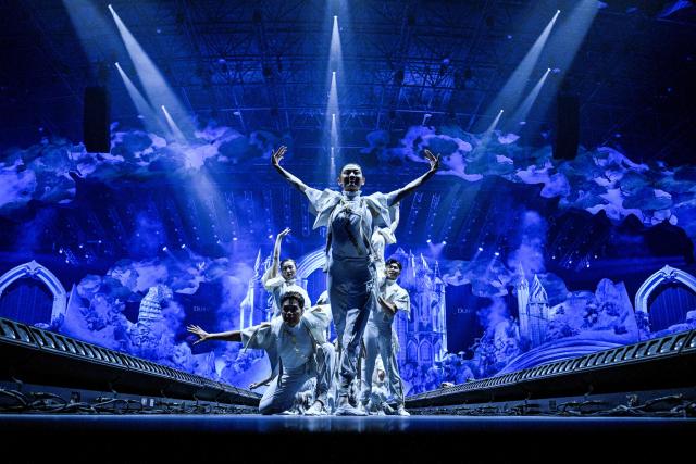 Artists dance during the first indoor showcase of electronic music festival 'The Magic of Tomorrowland' at the Hero Dome in Shanghai on November 22, 2025. (Photo by Hector RETAMAL / AFP)