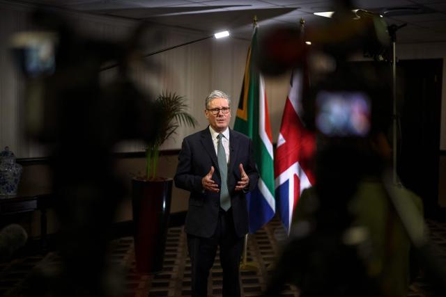 Britain's Prime Minister Keir Starmer (C) speaks during an interview with Beth Rigby from Sky News at a hotel in Johannesburg on November 22, 2025. (Photo by HENRY NICHOLLS / POOL / AFP)