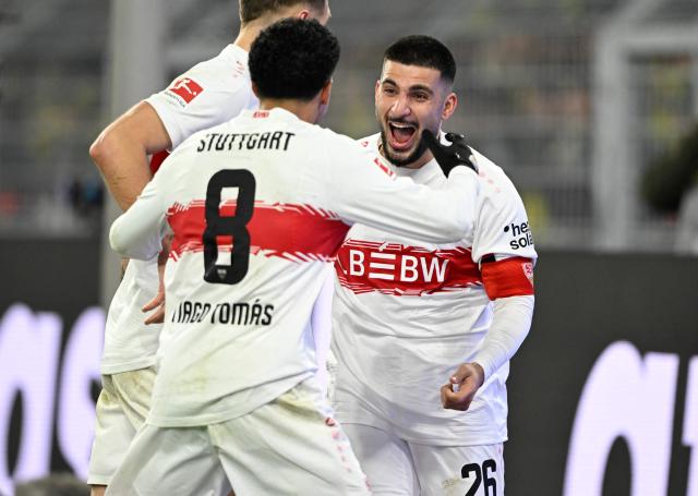 Stuttgart's German forward #26 Deniz Undav (R) celebrates scoring with Stuttgart's Portuguese forward #08 Tiago Tomas during the German first division Bundesliga football match between Borussia Dortmund and VfB Stuttgart in Dortmund on November 22, 2025. (Photo by INA FASSBENDER / AFP) / DFL REGULATIONS PROHIBIT ANY USE OF PHOTOGRAPHS AS IMAGE SEQUENCES AND/OR QUASI-VIDEO