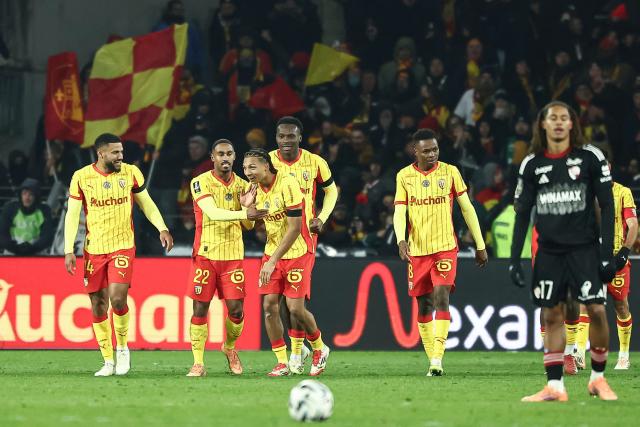 Lens' Burkinabe defender #37 Ismaelo Ganiou (3rd L) celebrates with team mates after scoring his team's first goal during the French L1 football match between RC Lens and RC Strasbourg Alsace at the Stade Bollaert-Delelis in Lens, northern France, on November 22, 2025. (Photo by Sameer Al-DOUMY / AFP)