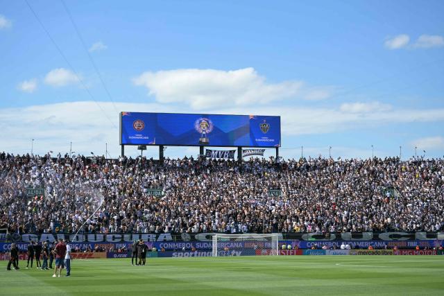 Atletico Mineiro fans are sprayed with water to cool off ahead of the Copa Sudamericana final football match between Argentina's Lanus and Brazil's Atletico Mineiro at the Defensores del Chaco stadium in Asuncion on November 22, 2025. (Photo by JUAN MABROMATA / AFP)