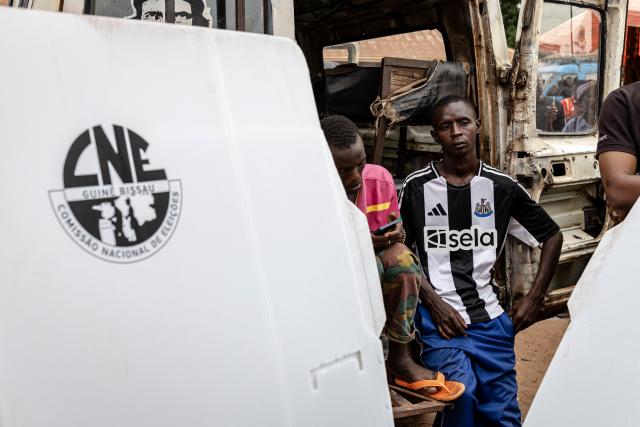 An official from the National Electoral Commission (CNE) stands next to a voting booth at their regional offices in Gabu, on November 22, 2025, on the eve of Guinea-Bissau’s general elections. Guinea-Bissau votes in general elections on November 23, 2025. (Photo by PATRICK MEINHARDT / AFP)