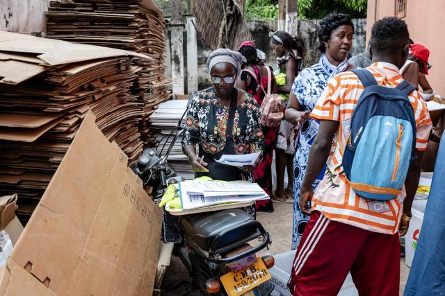 An official from the National Electoral Commission (CNE) checks electoral materials at their regional offices in Gabu, on November 22, 2025, on the eve of Guinea-Bissau’s general elections. Guinea-Bissau votes in general elections on November 23, 2025. (Photo by PATRICK MEINHARDT / AFP)