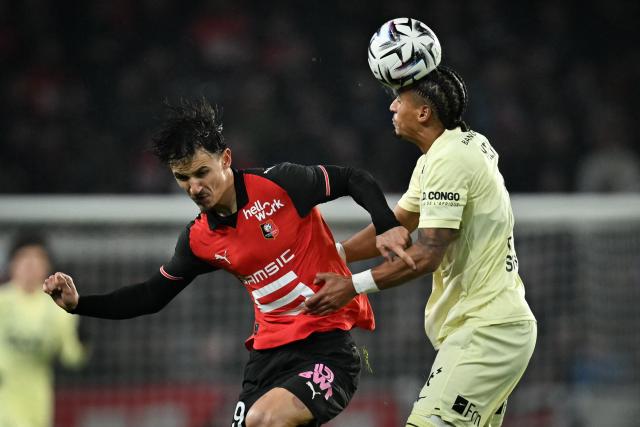 Monaco's German defender #05 Jan Thilo Kehrer (R) heads the ball past Rennes' French forward #09 Esteban Lepaul during the French L1 football match between Stade Rennais FC and AS Monaco at the Roazhon Park stadium in Rennes, western France, on November 22, 2025. (Photo by Lou BENOIST / AFP)