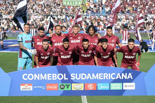 Lanus players pose for a team photo ahead of the Copa Sudamericana final football match between Argentina's Lanus and Brazil's Atletico Mineiro at the Defensores del Chaco stadium in Asuncion on November 22, 2025. (Photo by JUAN MABROMATA / AFP)