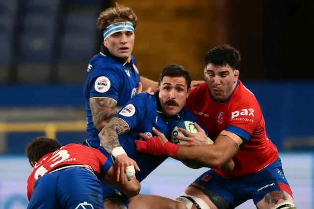 Italy's fly-half Giacomo Da Re (C) is tackled by Chile's flanker Clemente Saavedra (R) during the Autumn Nations Series international rugby union test match between Italy and Chile at Stadio Luigi Ferraris stadium in Genoa, on November 22, 2025. (Photo by MARCO BERTORELLO / AFP)