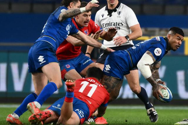 Italy's left wing Monty Ioane (R) is tackled by Chile's wing Nicolas Saab during the Autumn Nations Series international rugby union test match between Italy and Chile at Stadio Luigi Ferraris stadium in Genoa, on November 22, 2025. (Photo by MARCO BERTORELLO / AFP)