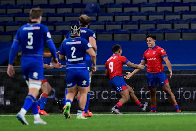 Chile's wing Nicolas Saab (R) celebrates with a teammate after scoring a try during the Autumn Nations Series international rugby union test match between Italy and Chile at Stadio Luigi Ferraris stadium in Genoa, on November 22, 2025. (Photo by MARCO BERTORELLO / AFP)
